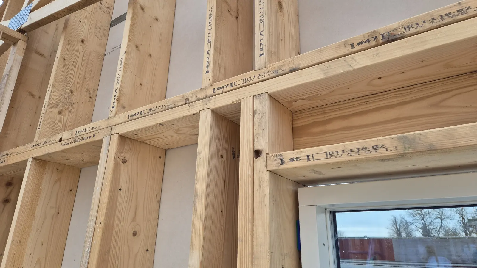 Close-up of GoFrame™ structural timber with ID codes and milled grooves