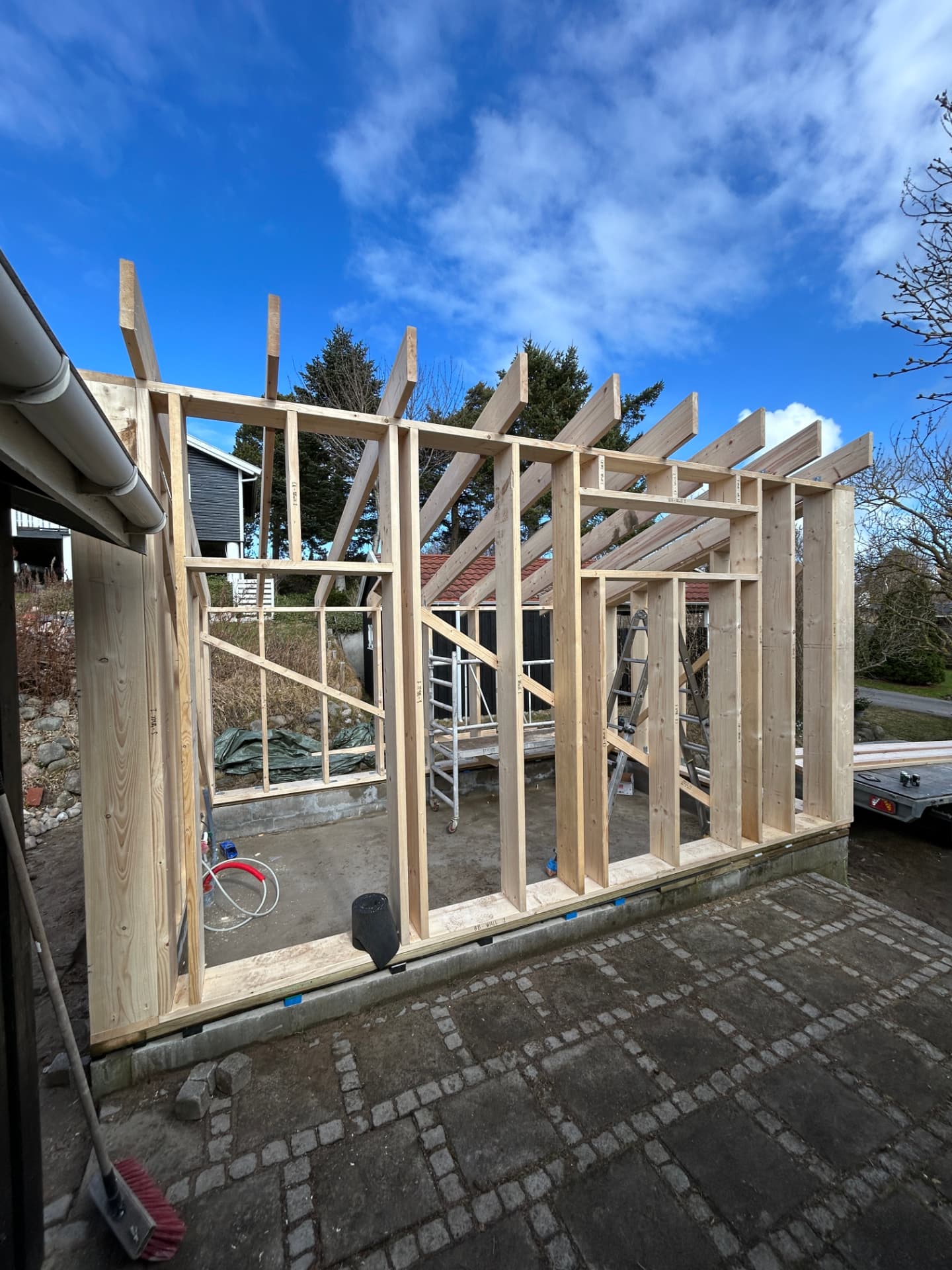 Labelled rafters and posts in the annex's erected timber frame