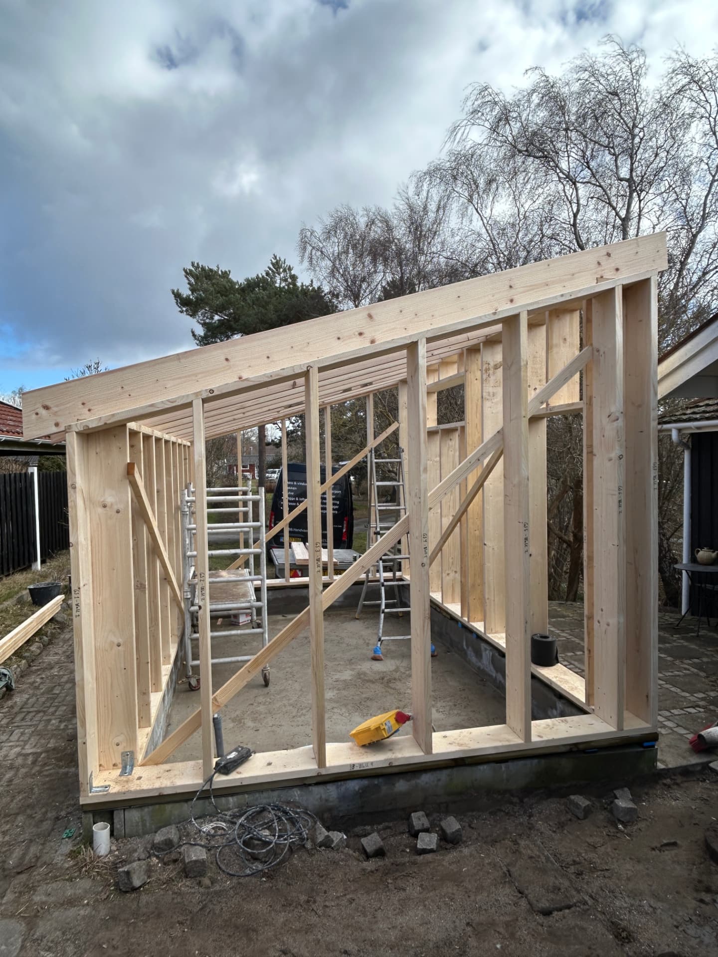 The annex's timber frame erected with the top plate and posts in place